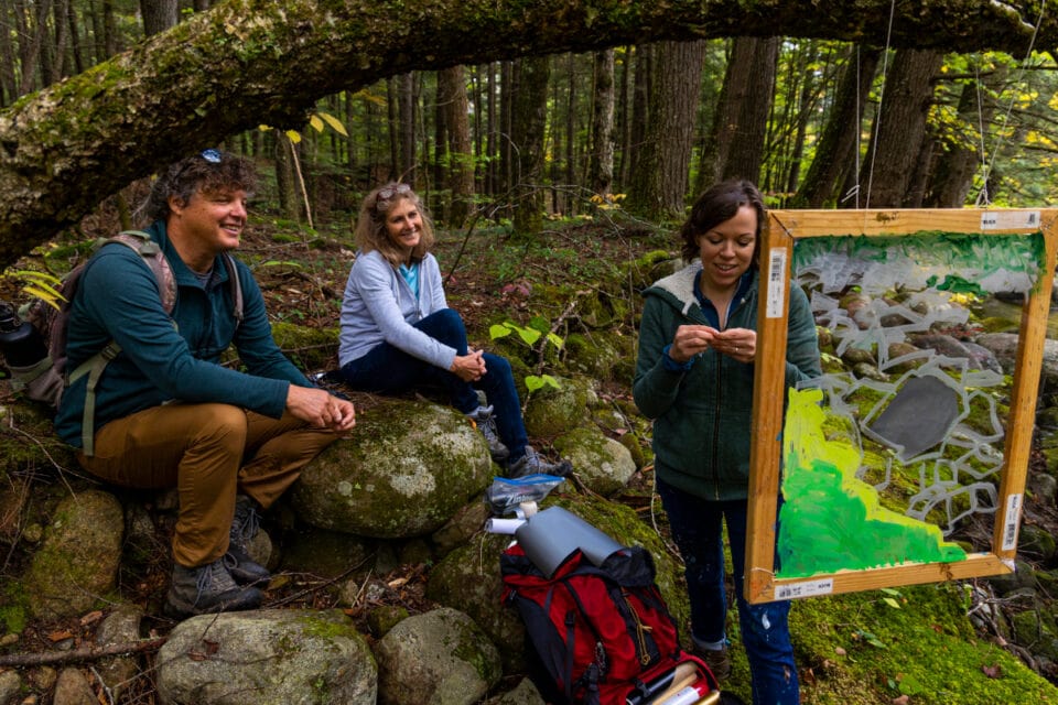 Artists Rita Leduc and Rich Blundell in the forest with scientist Lindsey Rustad. Photo by Joe Klementovich.